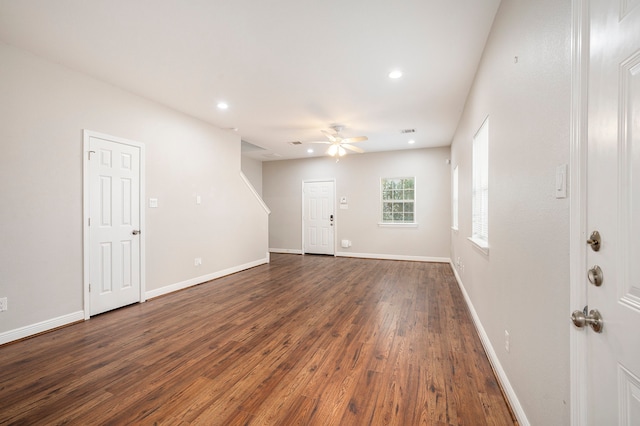 empty room with ceiling fan and dark hardwood / wood-style flooring