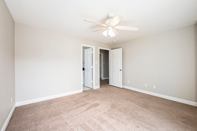 carpeted spare room with ceiling fan