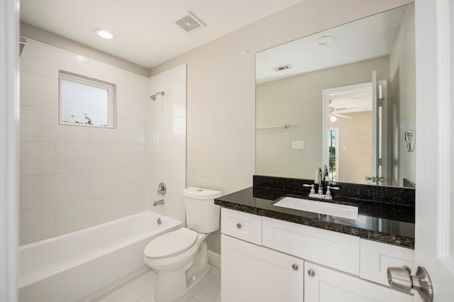 full bathroom with tiled shower / bath, vanity, toilet, and tile patterned flooring