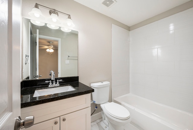 full bathroom featuring vanity, tiled shower / bath combo, toilet, and ceiling fan