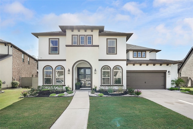 view of front of property with a front yard and a garage