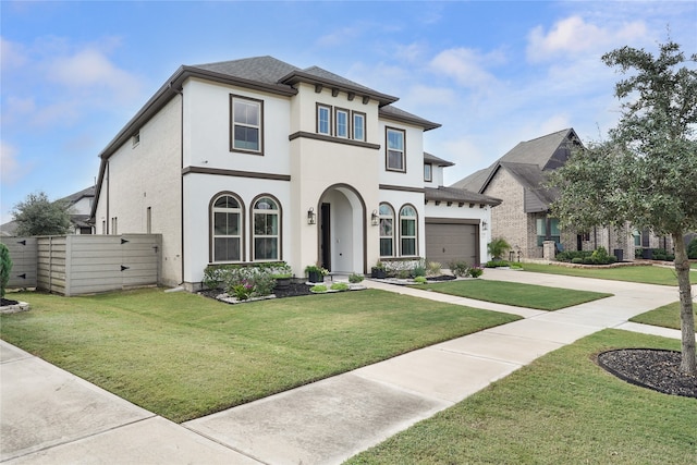 view of front facade with a front yard and a garage