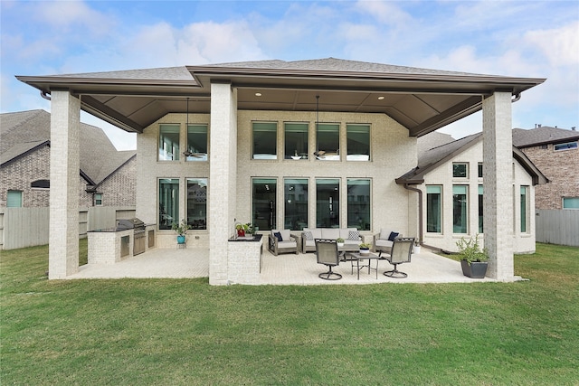 rear view of house featuring a patio area and a lawn