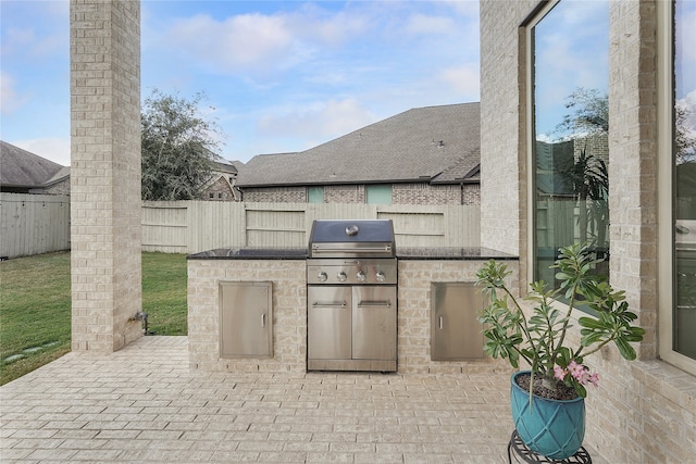 view of patio / terrace featuring a grill and exterior kitchen