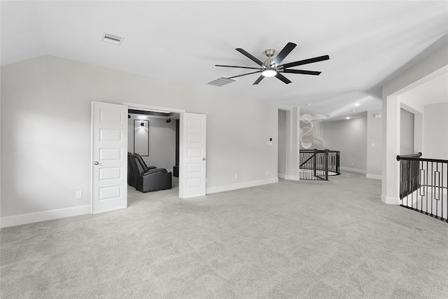 unfurnished room featuring ceiling fan, lofted ceiling, and light colored carpet