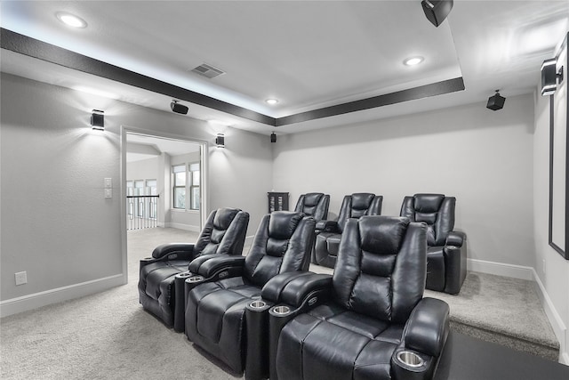 carpeted cinema with a tray ceiling