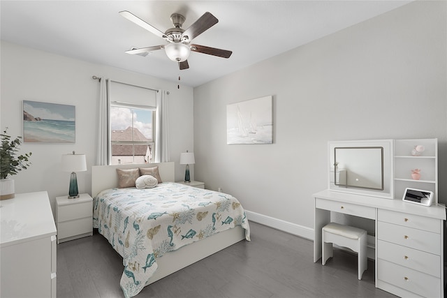 bedroom with dark hardwood / wood-style floors and ceiling fan