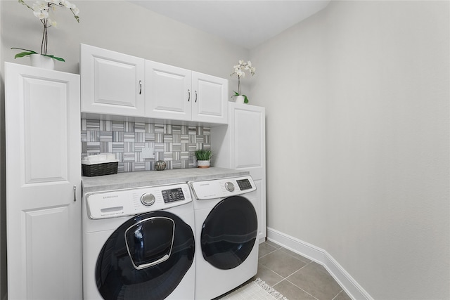 laundry area with light tile patterned flooring, separate washer and dryer, and cabinets