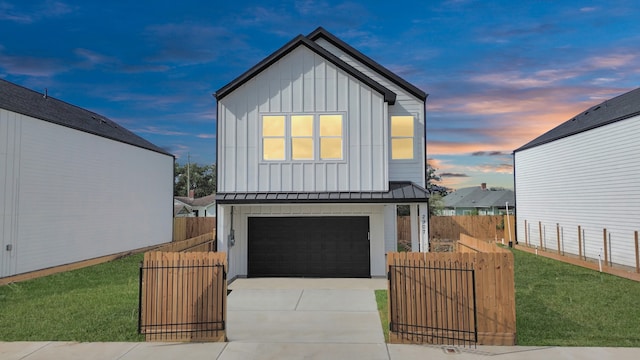 view of front of house featuring a garage and a lawn