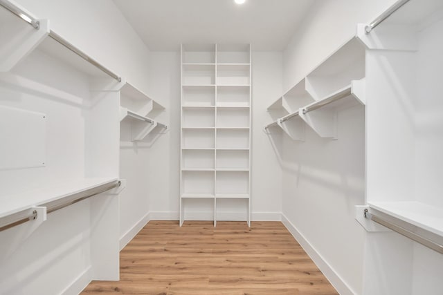 walk in closet with light wood-type flooring