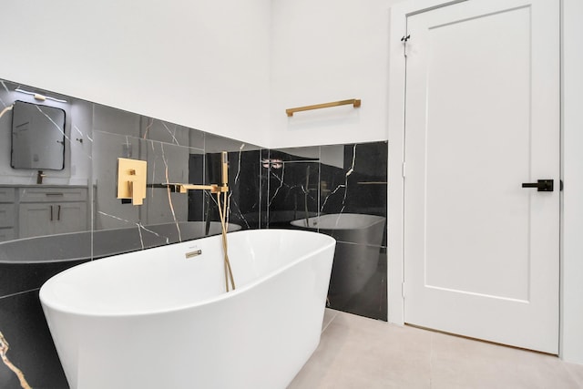 bathroom featuring tile patterned floors, tile walls, and a tub