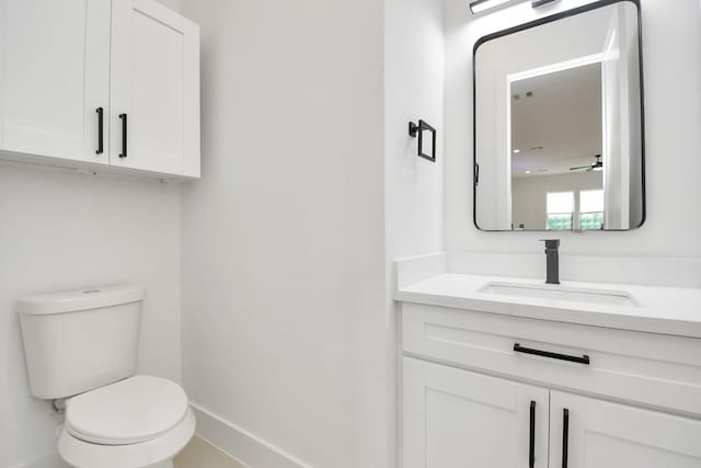 bathroom featuring ceiling fan, toilet, and vanity