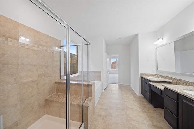 bathroom featuring tile patterned flooring, vanity, and plus walk in shower