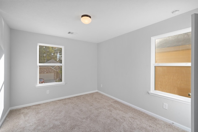 empty room featuring light carpet