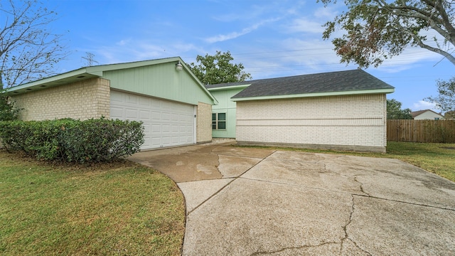 view of front of property with a front yard and a garage