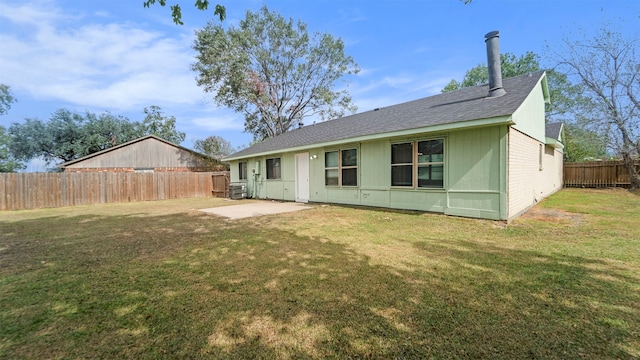 rear view of property with a yard