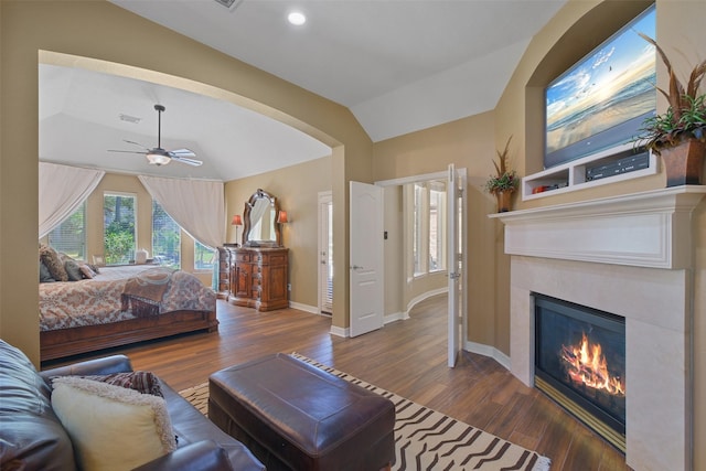 bedroom featuring ceiling fan, wood-type flooring, and vaulted ceiling