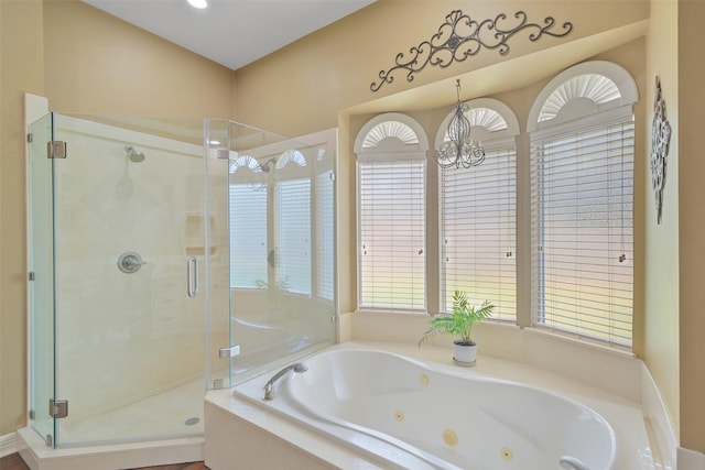 bathroom featuring independent shower and bath and a notable chandelier