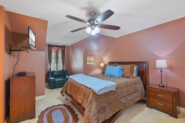 carpeted bedroom featuring ceiling fan and vaulted ceiling