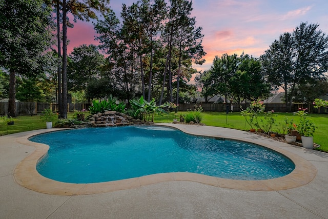 pool at dusk with a lawn