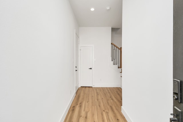 corridor with light hardwood / wood-style flooring