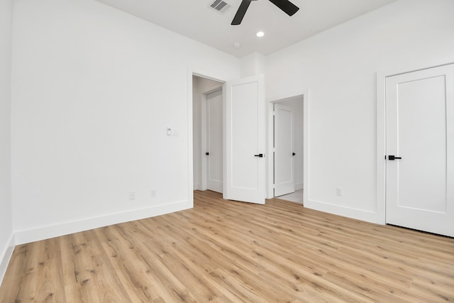 unfurnished bedroom with ceiling fan and light wood-type flooring