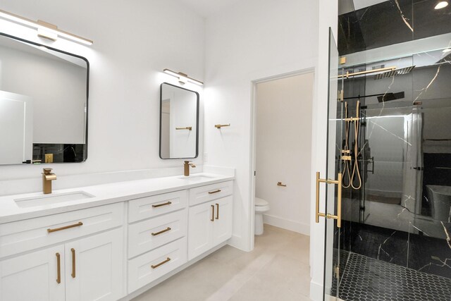 bathroom featuring vanity, toilet, and a shower with door