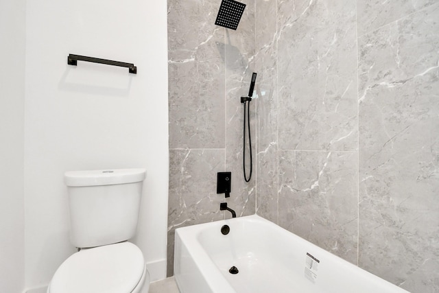 bathroom featuring toilet and bathing tub / shower combination