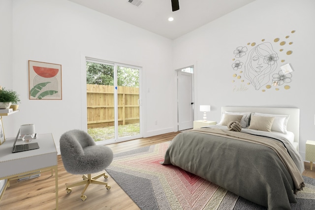 bedroom with recessed lighting, a high ceiling, wood finished floors, visible vents, and access to outside