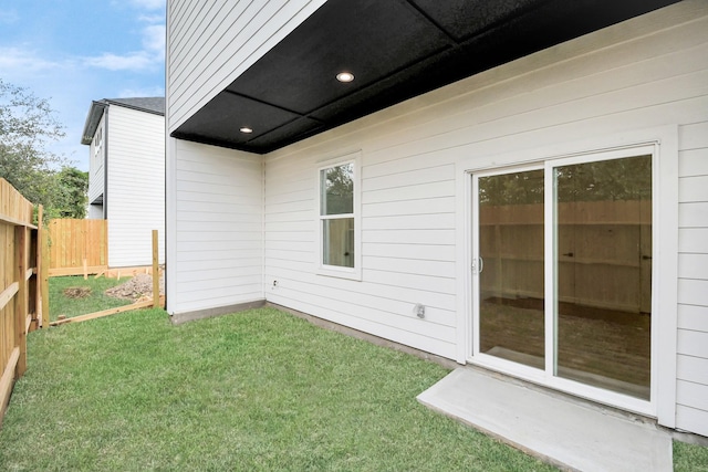 exterior space featuring a lawn and fence