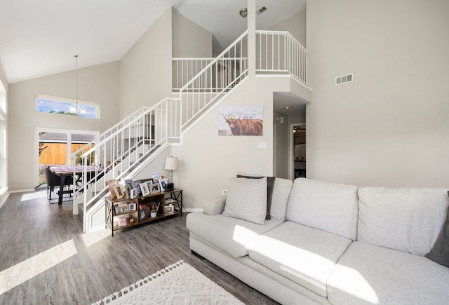 7415 Cavesson Dr, Cypress, TX 77433 - living room featuring stairway, high vaulted ceiling, wood finished floors, a chandelier, and baseboards