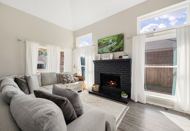 living room featuring hardwood / wood-style floors and a brick fireplace