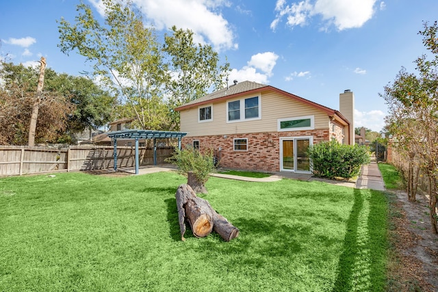 rear view of house with a patio, a lawn, and a pergola