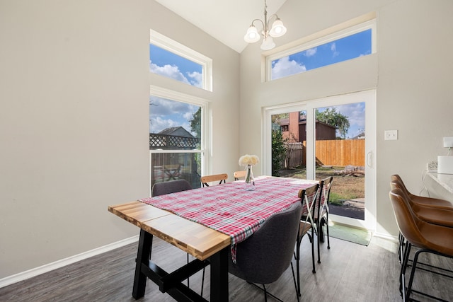 7415 Cavesson Dr, Cypress, TX 77433 - dining room featuring a chandelier, wood finished floors, high vaulted ceiling, and baseboards