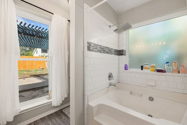 bathroom with hardwood / wood-style flooring and shower / bath combo