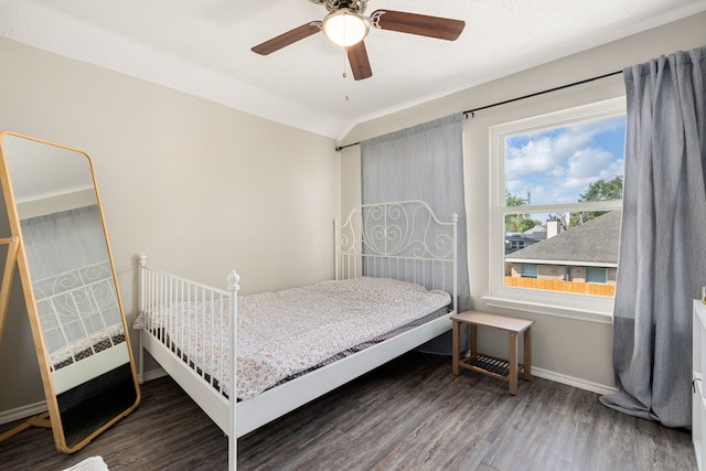 bedroom with ceiling fan and dark hardwood / wood-style flooring