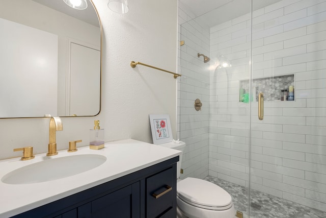 bathroom featuring vanity, toilet, and an enclosed shower