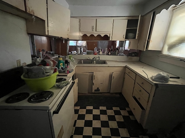 kitchen featuring white electric range oven and sink