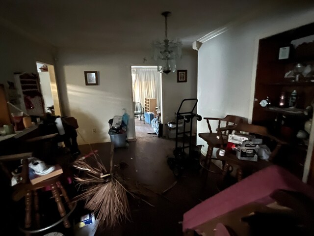 misc room with ornamental molding and an inviting chandelier