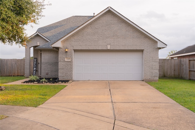 view of front facade with a front yard and a garage