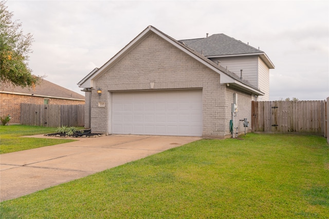 view of side of home featuring a yard and a garage