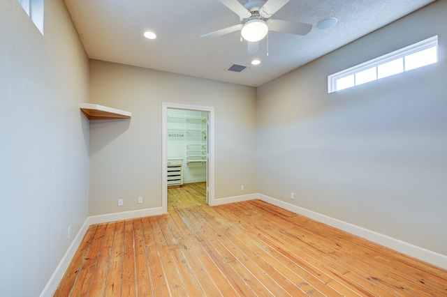 unfurnished room with ceiling fan and light hardwood / wood-style flooring