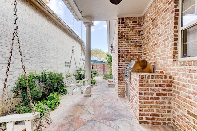view of patio with an outdoor kitchen and area for grilling