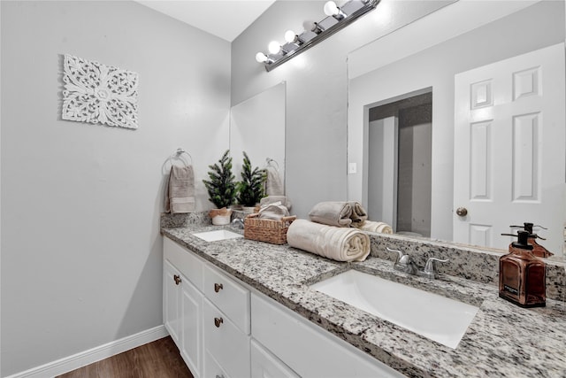 bathroom with vanity and hardwood / wood-style floors