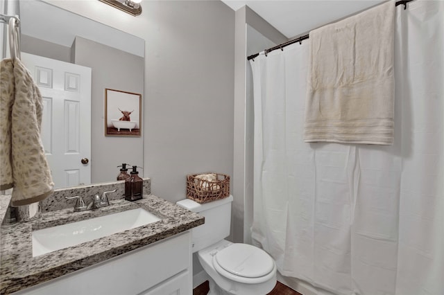 bathroom featuring vanity, a shower with curtain, and toilet