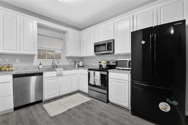 kitchen featuring sink, white cabinetry, stainless steel appliances, and light wood-type flooring