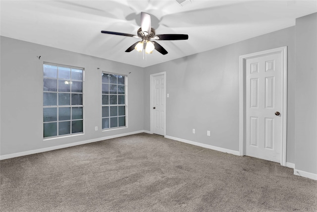 spare room featuring carpet and ceiling fan