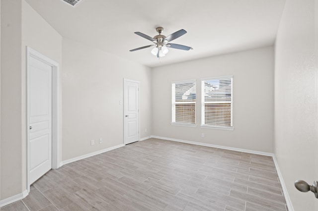 spare room featuring ceiling fan and light hardwood / wood-style flooring