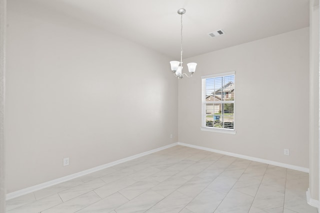 empty room featuring a chandelier