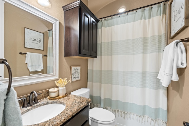 bathroom with vanity, a shower with curtain, and toilet